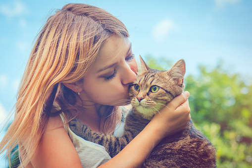 Woman and her cat outdoors in summer