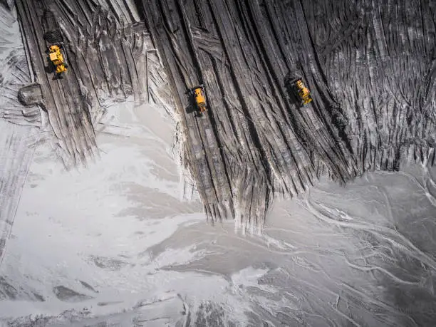 Photo of Aerial view over the building materials processing factory. Sand mine. View from above.