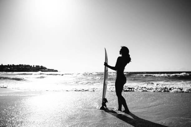 istock Black and white girl with surfboard 682316174