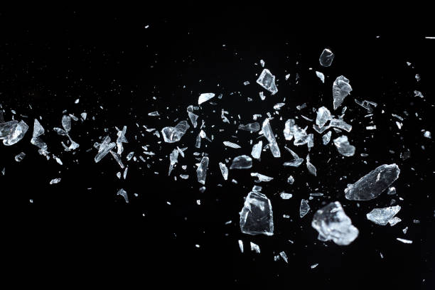 Flying sharp crystals fragments Broken crystal fragments on black background, studio shot, selective focus flying glass stock pictures, royalty-free photos & images