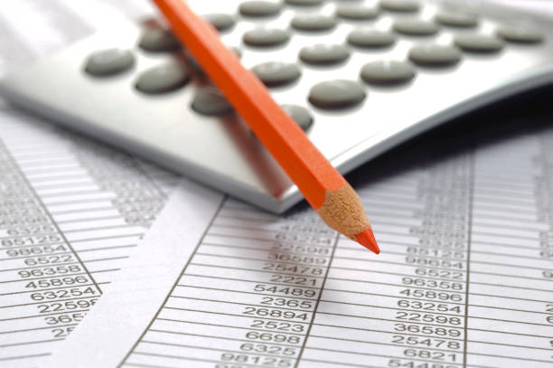 istock financial accounting with table sheet, red pencil and calculator 682319182