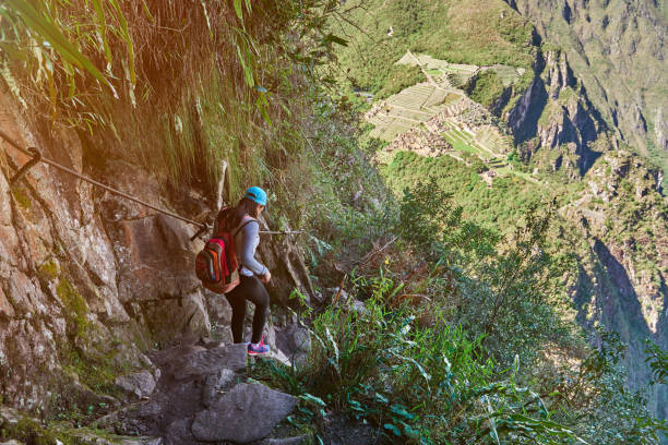 Young woman walk in machu picchu trail. Famous trail path in Peru