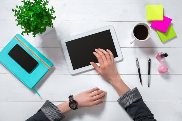 istock Overhead view of businesswoman working at computer in office 682321680