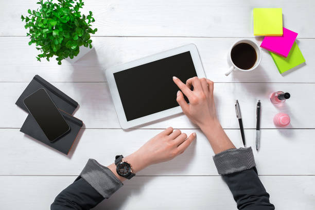 istock Overhead view of businesswoman working at computer in office 682321964