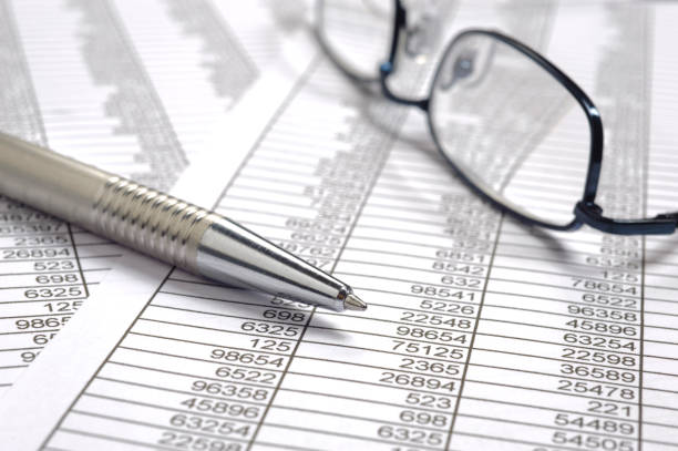 istock financial accounting with table sheet, red pencil and calculator 682322270