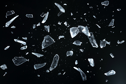 Sharp of broken crystal fragments on black background, studio shot, selective focus.