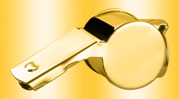 Golden whistle isolated against the gold background
