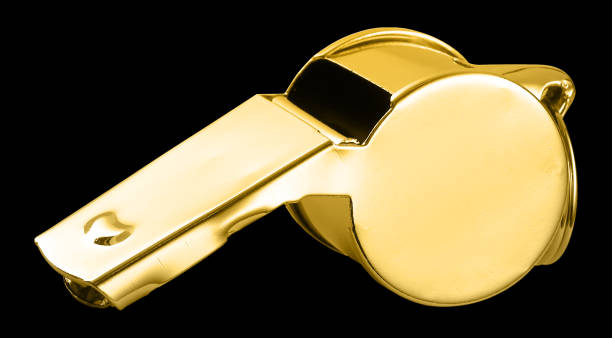 istock Golden whistle isolated against the black background 682322392