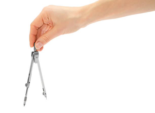 Close-up view of a man's hand with drawing compass, isolated on white background. Drafting instruments. Planning and engineering. Measurements. Workplace.
