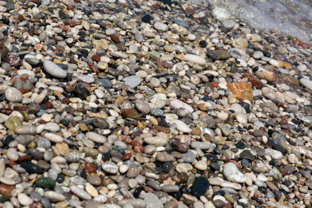 istock wet sea pebbles, colored stones on the coast 682328734