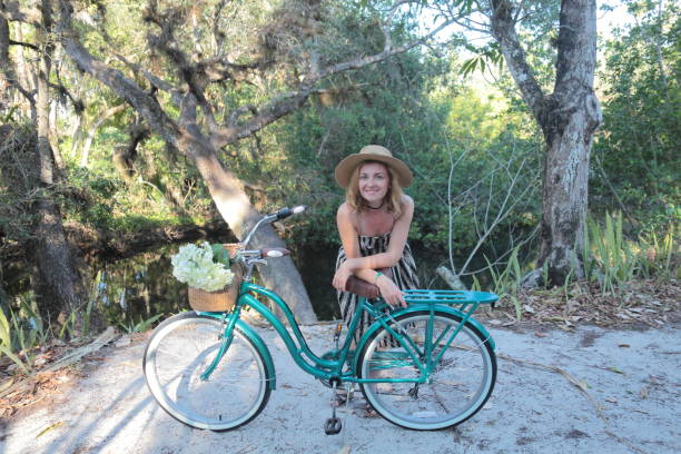 istock Woman riding bicycle in a tropical park. 682329654