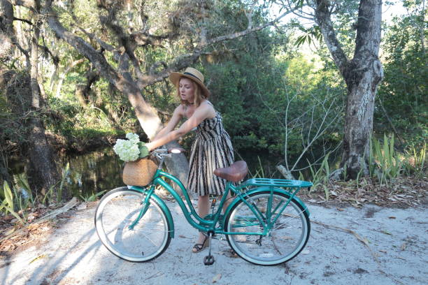 istock Woman riding bicycle in a tropical park. 682332528