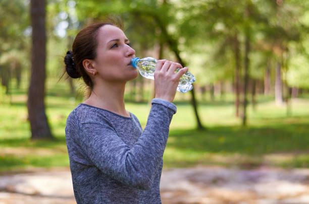 istock beautiful young girl outdoors drinking pure water 682332686