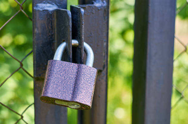istock a powerful padlock hanging on the closed doors 682334154