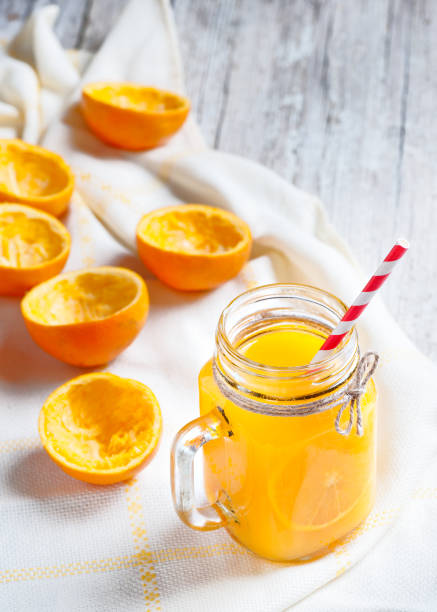 istock Orange juice isolated on white background with squeezed shells 682336960