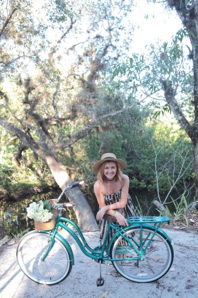 istock Woman riding bicycle in a tropical park. 682339896