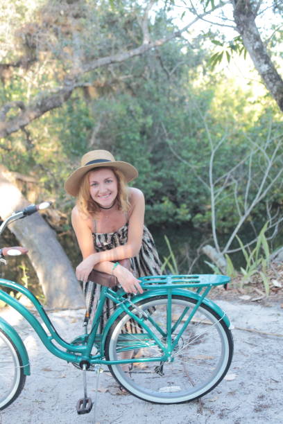 istock Woman riding bicycle in a tropical park. 682340038