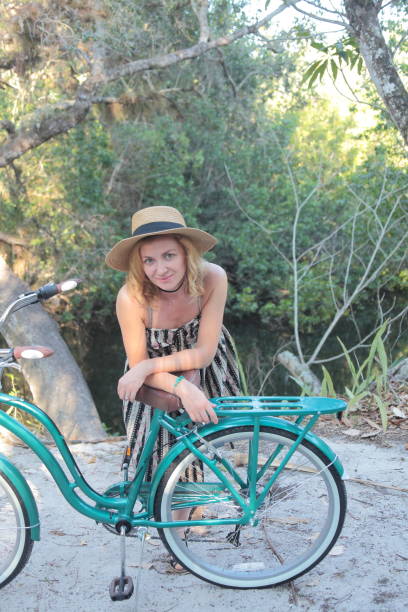 istock Woman riding bicycle in a tropical park. 682340042