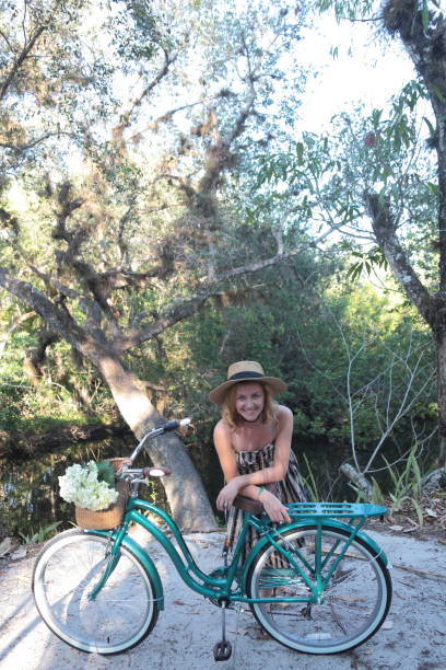 istock Woman riding bicycle in a tropical park. 682346058