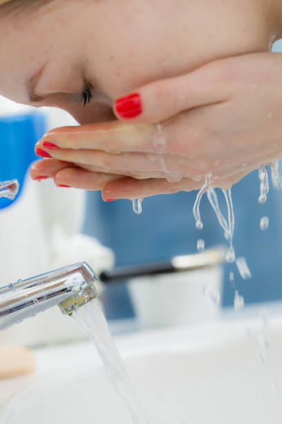 istock Woman washing face in bathroom. Hygiene. 682346302