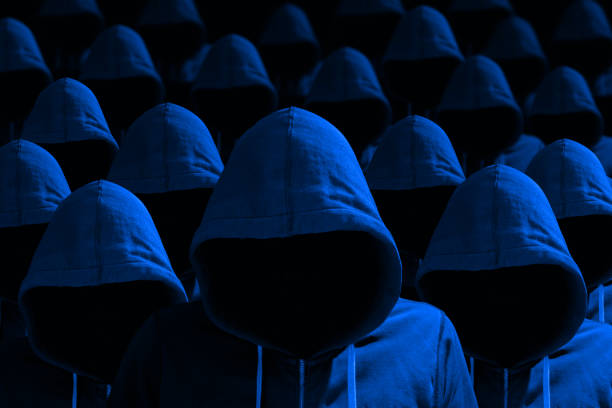 istock Group of hooded hackers in blue cybersecurity concept 682349850