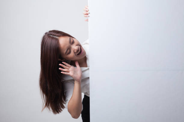 istock Excited young Asian woman with blank sign. 682350110