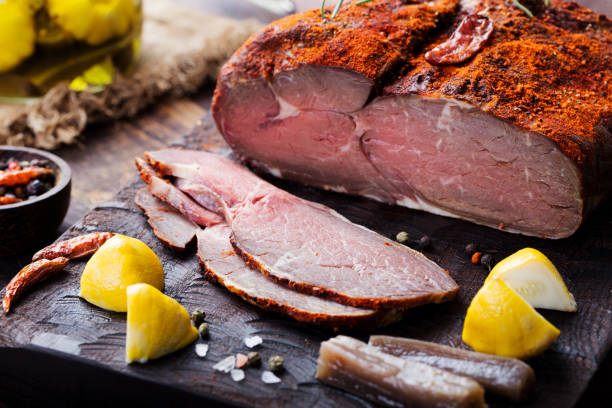 istock Beef pastrami sliced, roasted beef, slow cooking, on wooden board. 682352974