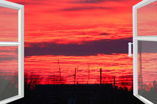 istock window opened to the beautiful scarlet sunset 682366996