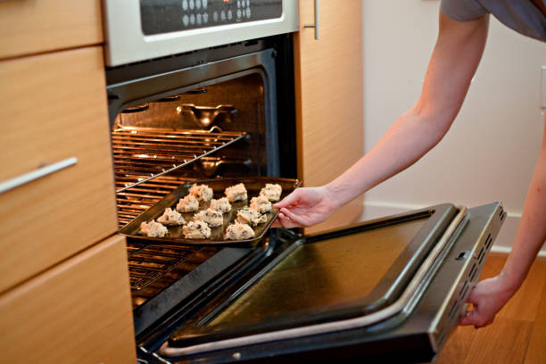 istock Putting Cookies in the Oven 682367266