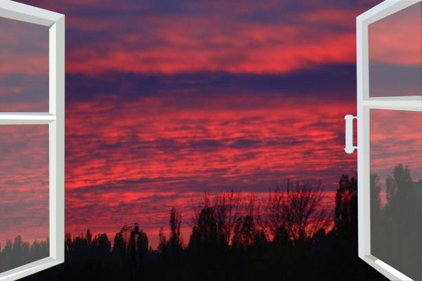 istock window opened to the beautiful scarlet sunset 682373830
