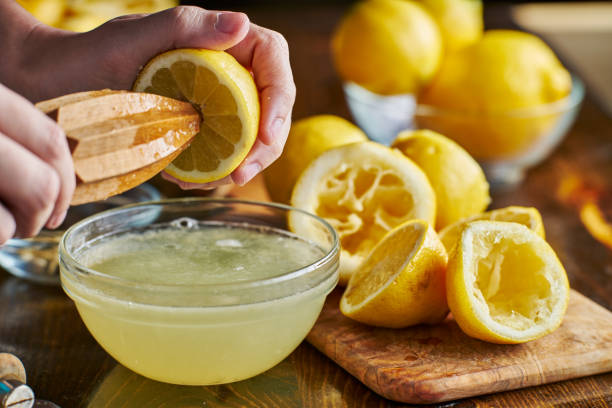 istock using wooden reamer to squeeze fresh lemon juice 682373846