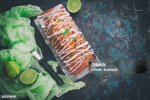 Homemade Glazed Lime Pound Cake Decorated With Mint On Vintage Table Stock Photo - Download Image Now