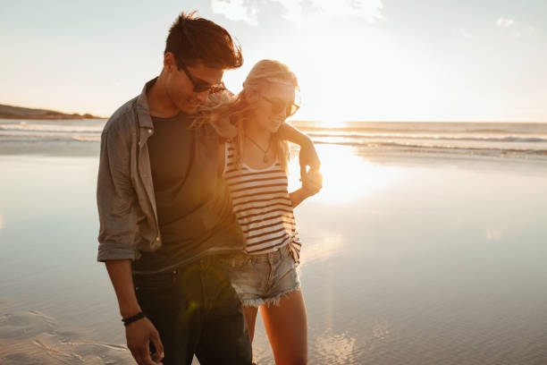 istock Romantic young couple on beach during sunset 682380370
