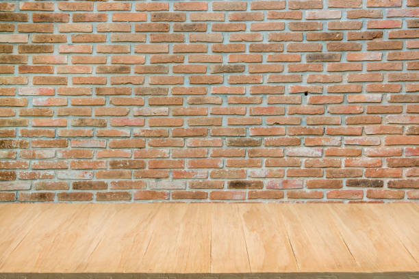 istock Wood floor with background of grunge red brick wall 682380452
