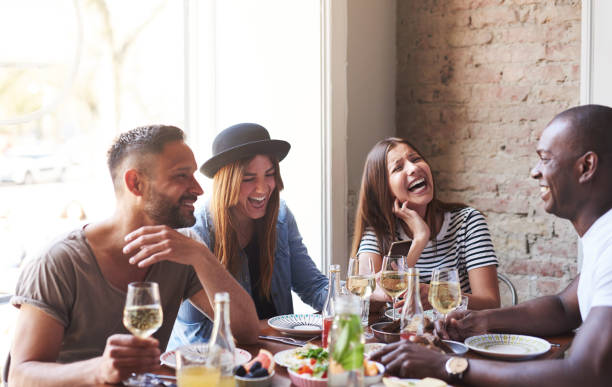 istock Young friends having dinner and laughing together 682388938