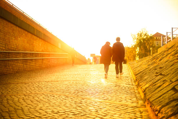 Photo of friends friends walking in the park at sunset