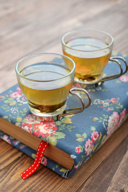 Green tea in a glass small cups over wooden background