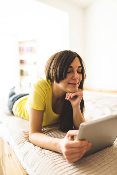 istock woman surfing on the web with the tablet 682402074