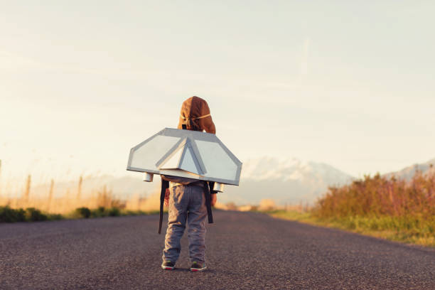 istock Young Boy with Jet Pack Looks to the Sky 682405882