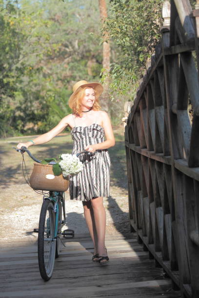 istock Woman riding bicycle in a tropical park. 682408966