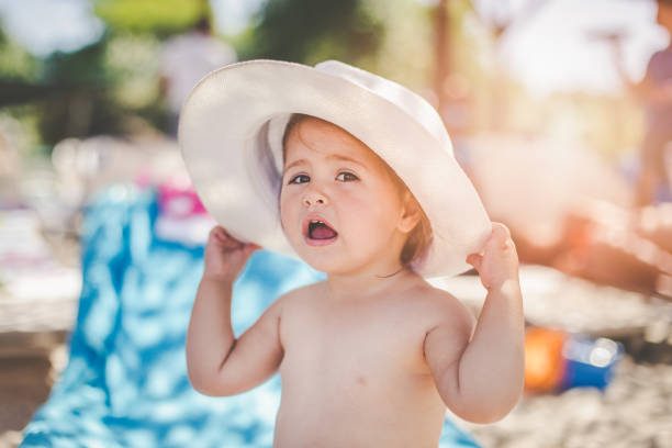 istock Baby girl wearing hat on the beach 682409004