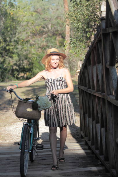 istock Woman riding bicycle in a tropical park. 682409246
