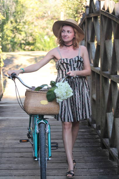 istock Woman riding bicycle in a tropical park. 682413268