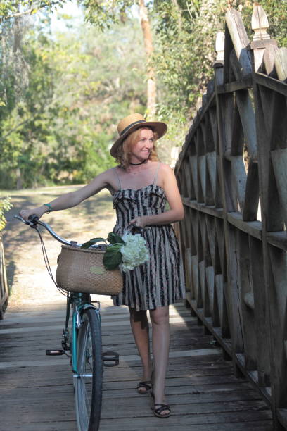 istock Woman riding bicycle in a tropical park. 682413348