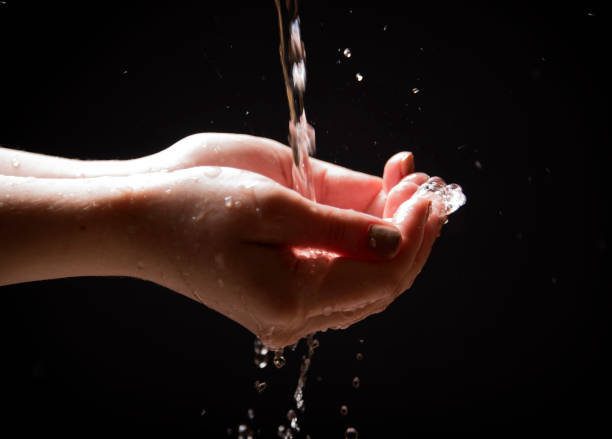 istock Water is poured into the palms of your hands 682413576