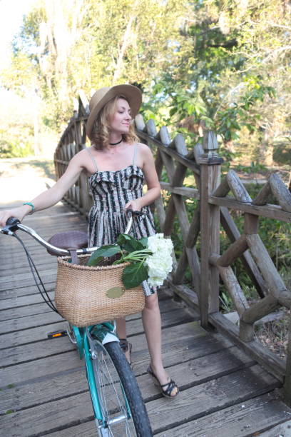 istock Woman riding bicycle in a tropical park. 682416310