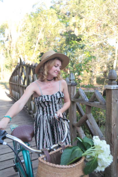 istock Woman riding bicycle in a tropical park. 682416736