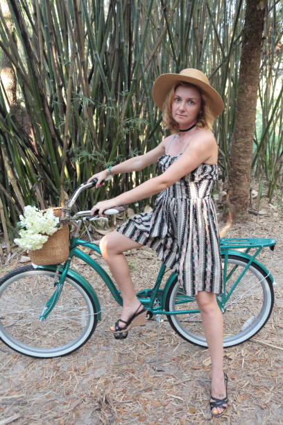 istock Woman riding bicycle in a tropical park. 682419436