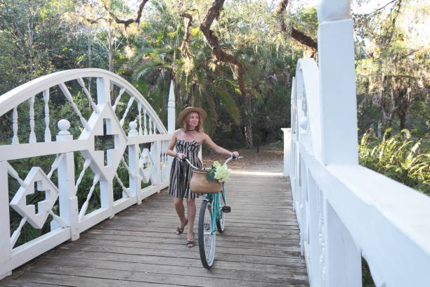 istock Woman riding bicycle in a tropical park. 682419814