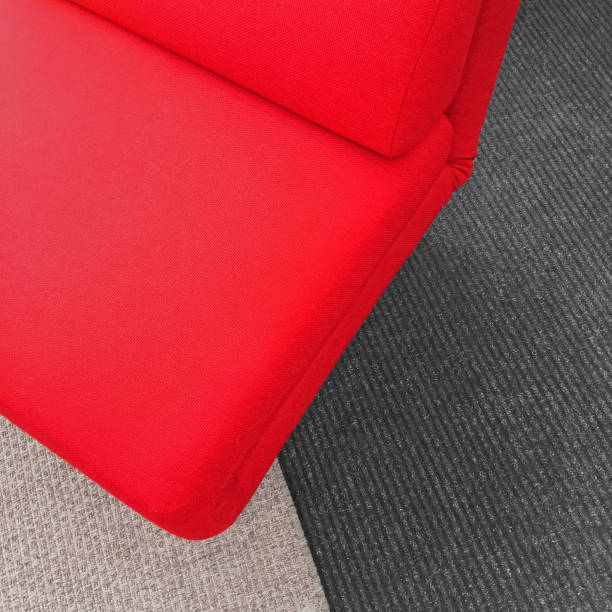 istock Vibrant soft red chair on gray carpet 682420142